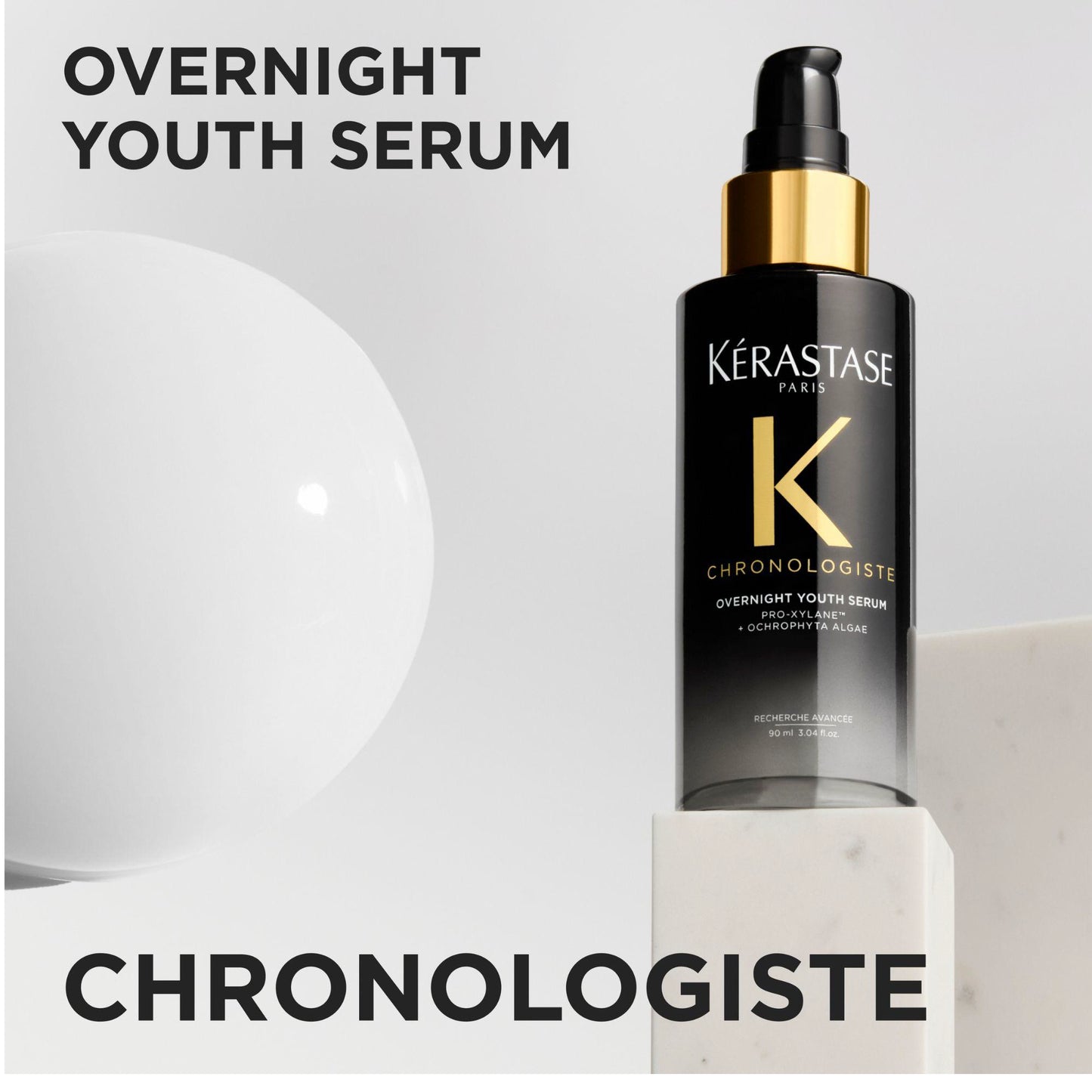 Kérastase Chronologiste Overnight Youth Serum in a black pump bottle with a gold collar, displayed on a white pedestal with text overlays.