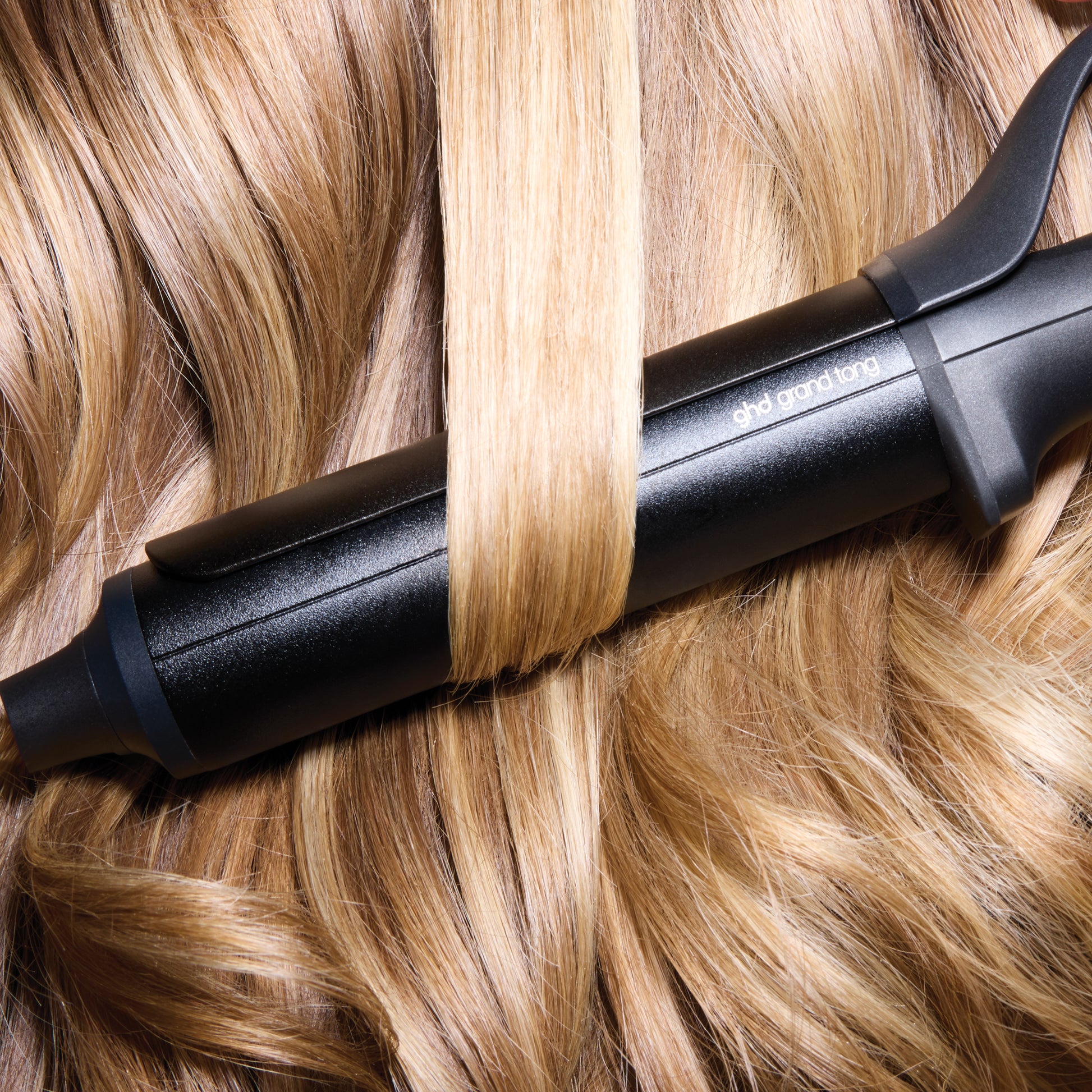 Black hair styling tool on blonde hair